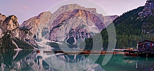 Boats on the Braies Lake Pragser Wildsee in Dolomites mountains, Sudtirol, Italy. Alps nature