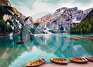 Boats on the Braies Lake Pragser Wildsee in Dolomites mountains Sudtirol Italy. Generated AI