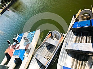 Boats and catamarans on a pond lake in a river canal with green