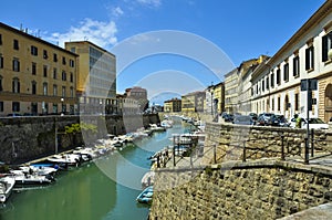 Boats in city channel in Livorno, Italy photo