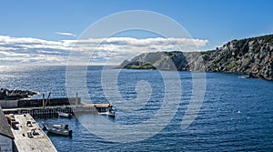 Boats at a cliffside dockhouse in Twillingate, Newfoundland.