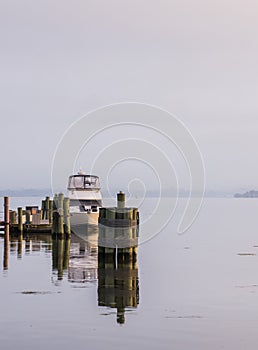 Boats docked along the Potomac River during a misty morning