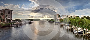 Boats docked in a harbor along the Cocohatchee River in Bonita Springs photo