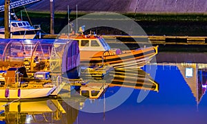 Boats docked in the harbor of Blankenberge at night, Belgium city architecture, water transportation