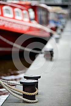 Boats docked in harbor bollards photo