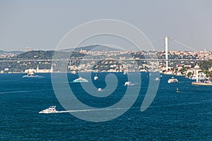 Boats and First Bosporus Bridge (15 July Martyrs Bridge) in Istanbul, Turk