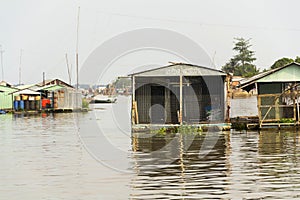 Boats with fish farm raft houses on Mekong river, Vietnam