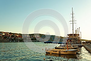 Boats and fishing trawler moored in the harbor of a small town Postira - Croatia, island Brac