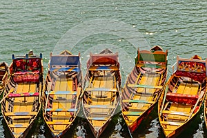 Boats floating on water in a lake in hill station Bhimtal in Nainital district of India photo