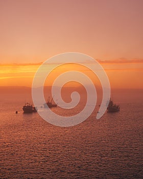 Boats in fog at sunset, in Lubec, Maine