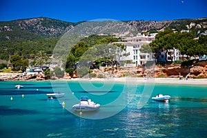 Boats in front of the beach in Portals Nous photo
