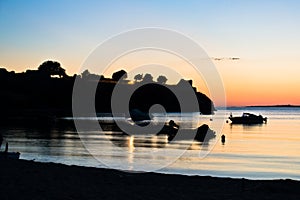 Boats in front of ruins of a roman fortress at sunset, Sithonia