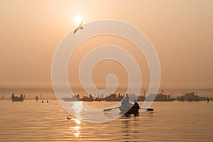 Boats on the Ganges River at Sunrise in Varanasi, India photo