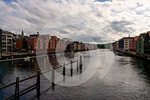 boats going down the river by colorful buildings in the city