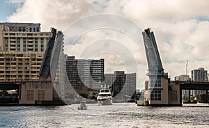 Boats going through open drawbridge