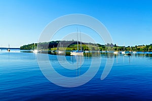 Boats and a green hill in Lunenburg Harbor