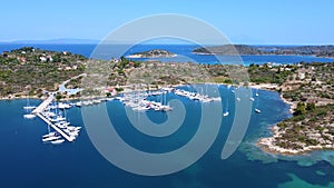Boats in harbor. Motorboats and sailboats in harbor on sunny summer day. Aerial view
