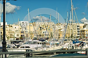 Boats in harbor of Valletta, capital of Malta. Scenic view of maltese coast with ships and traditional houses. Popular famous