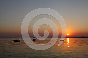 Boats harbored at Busaiteen beach during dawn