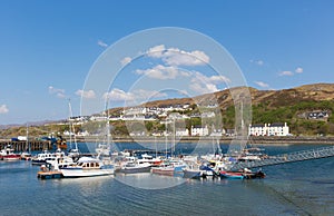 Boats in harbour Mallaig Scotland uk port on the west coast of the Scottish Highlands near Isle of Skye in summer with blue sky photo