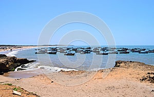 Boats in Harbour at Rocky and Sandy Coastline with Blue Sky and Ocean - Fisheries and Maritime Industry - Chorwad, Gujarat, India