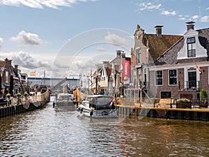 Boats in Het Dok canal near Oudesluis bridge in Lemmer, Friesland, Netherlands