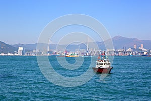 Boats in Hong Kong harbor and Stonecutters bridge