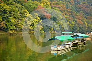 Boats on Katsura river at fall in Arashiyama, Kyoto