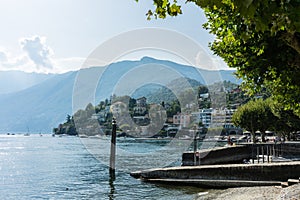 Boats on lago maggiore in ascona on lake with water reflection and mountain in the background photo