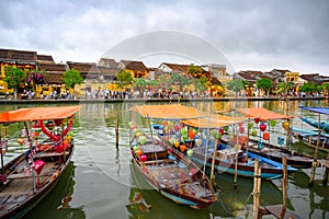 Boats with lampions on canal in tourist destination Hoi An, Vietnamese women in Hoi An, Vietnam