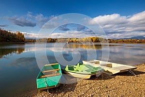 Boats on The Liptovska Mara dam in the morning light at autumn