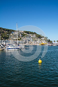 Boats and marina in L`Estartit city on the Costa Brava under blu photo