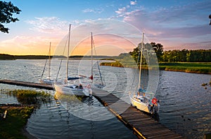 Boats moored at the gangplank on the Kirsajty Lake, Masuria