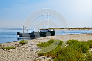 Boats are moored near the beach on the background of sea