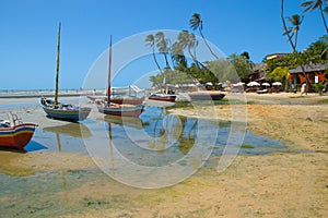 Boats moored on tropical beach