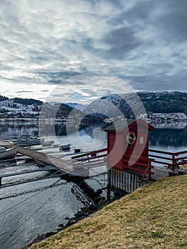 Boats near pier in Hardangerfjord in Norway photo