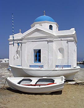 Boats next to seaside church, Mykonos, Greece