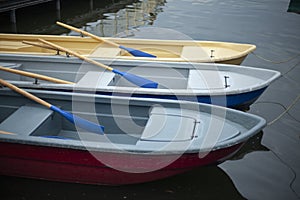 Boats at the pier. Pleasure boats for swimming on the lake. Lifeboats on the beach.