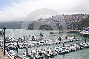 Boats in a port in Lastres with the village behind, Asturias photo