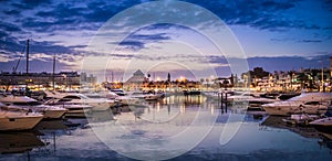 Boats in the port at Marina in Vilamoura, Algarve, Portugal under the cloudy sky