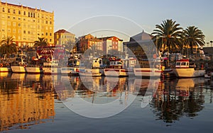 Boats Reflected in Golden Light at Fishing Port of Ferrol La Coruna Galicia