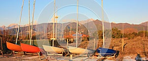 Boats resting on the beach in their parking area waiting for the summer