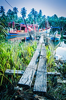 Boats by river bank