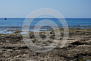 Boats sail on the Mediterranean Sea near the coast of Pefkos or Pefki, Rhodes island, Greece