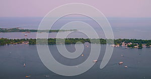 Boats sailing in lake Ontario, Canada. Cinematic shot of sailing boats in harbor near airport at sunset. Enjoy nice view