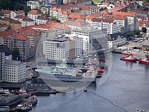 boats are sailing near the harbor at the city of bergen