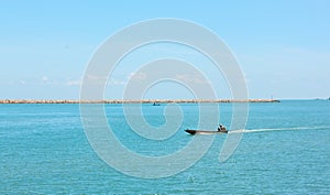 boats are sailing on the sea background in the noon time.