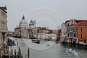 Boats and ships on the canal between the buildings in Venice, Italy