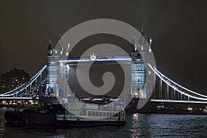 Boats and ships at london tower bridge at night