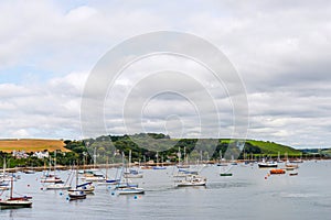 Boats and ships moored in a small port, in the background coastal town, fishing industry and tourism